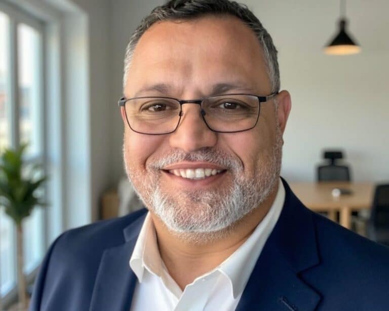 Smiling man in professional attire.