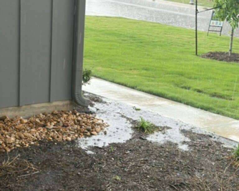 Rainwater pooling near building foundation